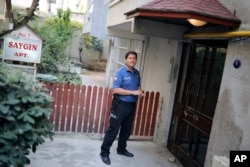 A Turkish police officer stands outside the house of American Pastor Andrew Craig Brunson, a 50-year-old evangelical pastor from Black Mountain, North Carolina, before his arrival, in Izmir, Turkey, July 25, 2018, after his release from a jail near Izmir.