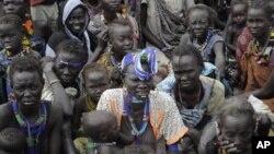 Victims of ethnic violence in Jonglei, South Sudan, wait in line at the World Food Program distribution center in Pibor to receive emergency food rations on Jan.12, 2012.
