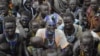 Victims of ethnic violence in Jonglei, South Sudan, wait in line at the World Food Program distribution center in Pibor to receive emergency food rations on Jan.12, 2012.