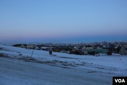 Children sled down "media hill" at the Standing Rock camp (E. Sarai/VOA)