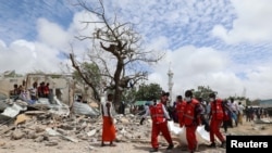 Rescuers carry the dead body of an unidentified man from the scene of an explosion to an ambulance in Hodan district, Mogadishu, Somalia September 10, 2018. 