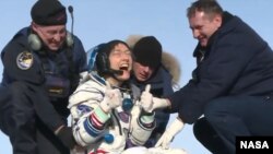 Christina Koch gives a thumbs-up signal as she leaves the Soyuz capsule in which she returned on Feb. 6, 2020.