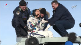Christina Koch gives a thumbs-up signal as she leaves the Soyuz capsule in which she returned on Feb. 6, 2020.