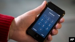 An iPhone is seen in a file photo. The FBI says that compelling Apple to help unlock an extremist’s iPhone should be safe and straightforward, but security experts say it’s not so simple.