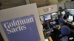 A trader works in the Goldman Sachs booth on the floor of the New York Stock Exchange, March 15, 2012.
