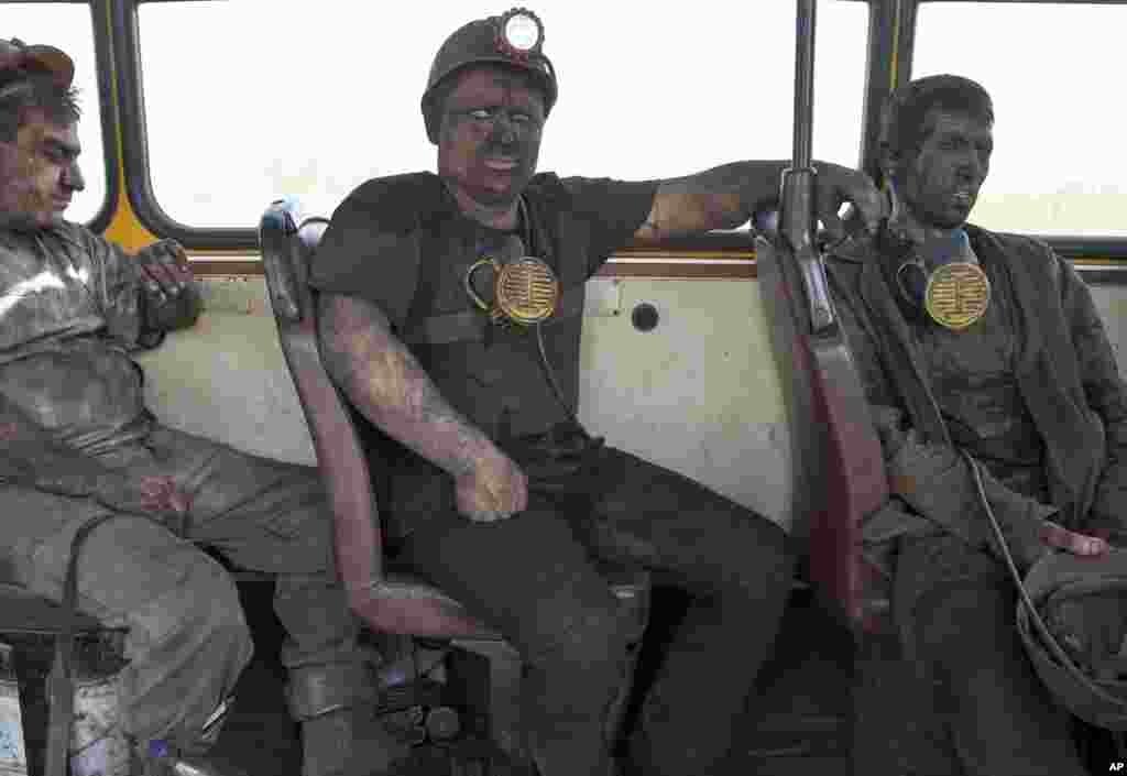 Coal miners sit on a bus after finishing their shift at a coal mine outside Donetsk, Ukraine, May 20, 2014. 