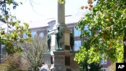 A student reads a book on campus, at Ohio University. 