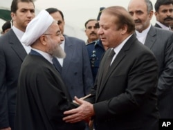 In this photo released by Press Information Department, Pakistan's PM Nawaz Sharif (R) receives visiting Iranian President Hassan Rouhani in Islamabad, Pakistan, March 25, 2016. This is Rouhani's first visit to Pakistan since taking office.