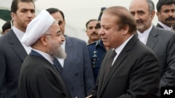 In this photo released by Press Information Department, Pakistan's PM Nawaz Sharif (R) receives visiting Iranian President Hassan Rouhani in Islamabad, Pakistan, March 25, 2016. This is Rouhani's first visit to Pakistan since taking office in 2013.