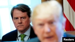 FILE - White House Counsel Don McGahn sits behind U.S. President Donald Trump as the president holds a cabinet meeting at the White House in Washington, June 21, 2018.