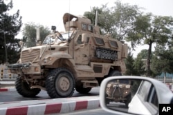 FILE - A U.S. armored vehicle patrols in Kabul, Afghanistan,, Aug. 23, 2017.
