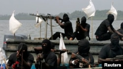FILE - Militants are seen patrolling the creeks of the Niger Delta region of Nigeria, Jan. 30, 2007. 