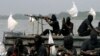 FILE - Militants are seen patrolling the creeks of the Niger delta region of Nigeria, Jan. 30, 2007. 