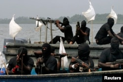 FILE - Militants are seen patrolling the creeks of the Niger delta region of Nigeria, Jan. 30, 2007.