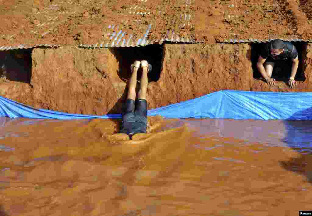 Competitors exit a tunnel as they participate in the Alpha League Races in Bengaluru, India. Around 2000 people participated in the 5-km endurance race with 20 different obstacles, organizers said.