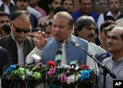 FILE - Nawaz Sharif addresses a crowd during his visit to a mausoleum of Pakistani poet Mohammad Iqbal on the occasion of Pakistan Independence Day in Lahore, Aug. 14, 2017.