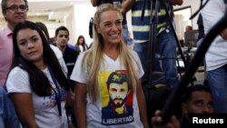 Lilian Tintori (C), wife of jailed opposition leader Leopoldo Lopez, wearing a T-shirt depicting her husband, smiles as she arrives at a news conference in Caracas, Venezuela, Dec. 7, 2015.