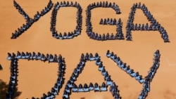 School children sit as they form the word "Yoga Day" on the International Yoga Day in Chennai, India.