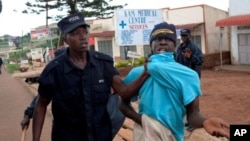 A supporter of opposition leader Kizza Besige is arrested during a rally on August 17, 2011 in memory of 10 people killed in a crackdown on protests in April
