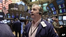 Trader James Doherty works on the floor of the New York Stock Exchange, August 12, 2011