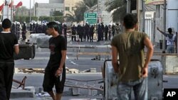 Bahraini riot police and soldiers move in on anti-government protesters March 25, 2011, in the western Shi'ite Muslim village of Malkiya, firing tear gas when villagers defied martial law by holding a protest march