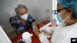 Norma Gonzalez, 68, is tested for the COVID-19 virus, in a Red Cross laboratory in Tegucigalpa, Honduras, Friday, April 23, 2021. (AP Photo/Elmer Martinez)