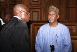 FILE - Former National Security Adviser Sambo Dasuki, right, arrives with one of his counsels Ahmed Raji at the Federal High Court in Abuja, Nigeria, Sept. 1, 2015.