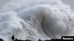 A person views large waves as Storm Eowyn arrives, in Porthcawl, Wales, Britain, Jan. 24, 2025.