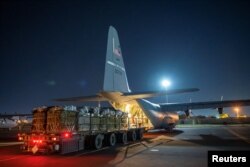 FILE —Over 38,000 Meals Ready to Eat and water destined for an airdrop over Gaza are loaded aboard a U.S. Air Force C-130J Super Hercules at an undisclosed location in Southwest Asia, March 1, 2024.