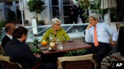 U.S. Secretary of State John Kerry, right, U.S. Under Secretary for Political Affairs Wendy Sherman, center, National Security Council point person on the Middle East Robert Malley, and Chief of Staff Jon Finer, front, meet on the terrace of a hotel where