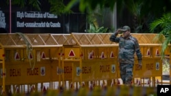 An Indian paramilitary soldier stands guard next to a police barricade outside the Canadian High Commission in New Delhi, India, Tuesday, Sept. 19, 2023. 