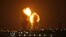Two balls of fire are seen following an Israel airstrike in Khan Yunis in the southern Gaza Strip early Nov. 15, 2019.