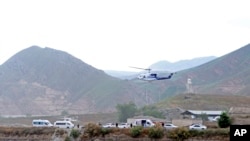 In this photo provided by Islamic Republic News Agency, IRNA, the helicopter carrying Iranian President Ebrahim Raisi takes off at the Iranian border with Azerbaijan after President Raisi and his Azeri counterpart Ilham Aliyev inaugurated a dam in Azeri, Iran, May 19, 2024. 