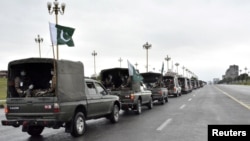 An army convey patrols during a partial lockdown after Pakistan shut all markets, public places and discouraged large gatherings amid an outbreak of coronavirus disease (COVID-19), in Islamabad, March 24, 2020.