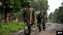 M23 rebel group soldiers patrol in Rangira, near Rutshuru, DRC, October 17, 2012.