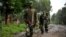 M23 rebel group soldiers patrol in Rangira, near Rutshuru, DRC, October 17, 2012.