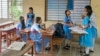 (FILE) School girls sit in a classroom, in Dhaka on August 7, 2024, after former prime minister Sheikh Hasina fled Bangladesh.