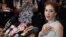 Miss Universe Thailand Weluree Ditsayabut speaks during a news conference at Renaissance Hotel in Bangkok. Ditsayabut renounced her title over remarks she made on social media including one that "red shirt" activists, supporters of ousted prime minister Yingluck Shinawatra, should all be executed.