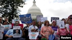 FILE - Activists participate in a rally to protect the Affordable Care Act outside the U.S. Capitol in Washington, Sept. 19, 2017. 