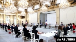 French President Emmanuel Macron, French Prime Minister Jean Castex and members of the new government attend their first Cabinet meeting at the Elysee Palace in Paris, July 7, 2020.