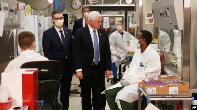 Vice President Mike Pence visits the molecular testing lab at Mayo Clinic Tuesday, April 28, 2020, in Rochester, Minn., where he toured the facilities supporting COVID-19 research and treatment. Pence chose not to wear a face mask while touring the…