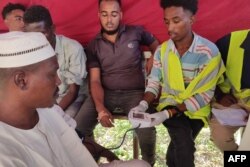 FILE - People queue at a medical laboratory to get tested for Dengue fever in the eastern Gedaref state of War-torn Sudan on September 22, 2023, amid reports of the spread of the viral infection.