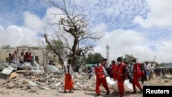 Rescuers carry the dead body of an unidentified man from the scene of an explosion to an ambulance in Hodan district, Mogadishu, Somalia September 10, 2018.