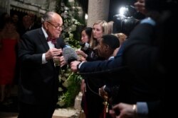 FILE - Rudy Giuliani, an attorney for President Donald Trump, speaks to reporters as he arrives for a New Year's Eve party at Trump's Mar-a-Lago property in Palm Beach, Fla., Dec. 31, 2019.