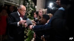 U.S. President Donald Trump's personal attorney Rudy Giuliani speaks to reporters as he arrives for a New Year's Eve party hosted by Trump at his Mar-a-Lago property, Dec. 31, 2019, in Palm Beach, Florida.