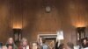 Family members hold picture of miners killed in US mining explosion at congressional hearing, 27 Apr 2010