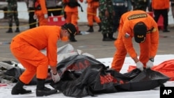 Rescuers carry a body bag containing human remains recovered from the waters where Sriwijaya Air passenger jet crashed, at Tanjung Priok Port in Jakarta, Indonesia, Sunday, Jan. 10, 2021. 