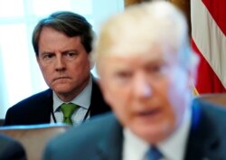 FILE - White House Counsel Don McGahn sits behind U.S. President Donald Trump as the president holds a cabinet meeting at the White House in Washington, June 21, 2018.