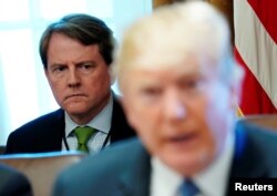 FILE - White House Counsel Don McGahn sits behind U.S. President Donald Trump as the president holds a cabinet meeting at the White House in Washington, June 21, 2018.