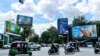 Billboards advertising alcohol seen along main roads as commuters cross the Chamkarmon intersection in Phnom Penh, on Oct. 29, 2021. (Kann Vicheika/VOA Khmer)